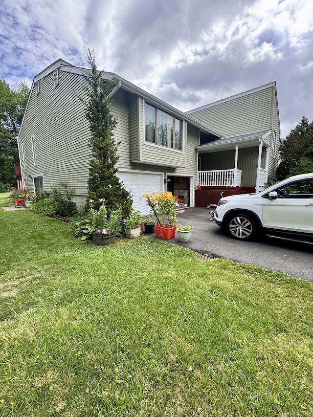 70 Regency Dr, Windsor, CT 06095 - view of property exterior featuring an attached garage, asphalt driveway, and a lawn