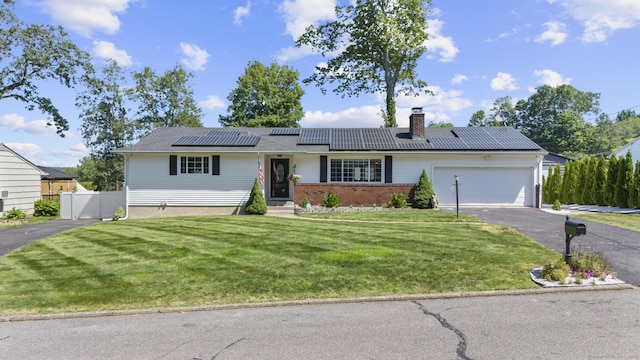 24 Pine Tree Rdg, Meriden, CT 06450 - ranch-style house featuring asphalt driveway, a chimney, a garage, solar panels, and brick siding