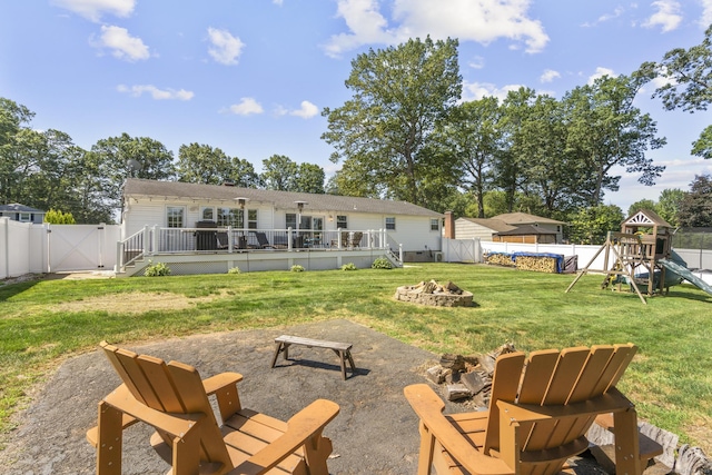 24 Pine Tree Rdg, Meriden, CT 06450 - rear view of house with an outdoor fire pit, a gate, a playground, a fenced backyard, and a wooden deck