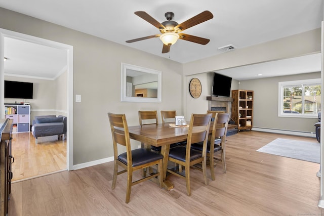 24 Pine Tree Rdg, Meriden, CT 06450 - dining space with a baseboard heating unit, light wood finished floors, ceiling fan, and a fireplace
