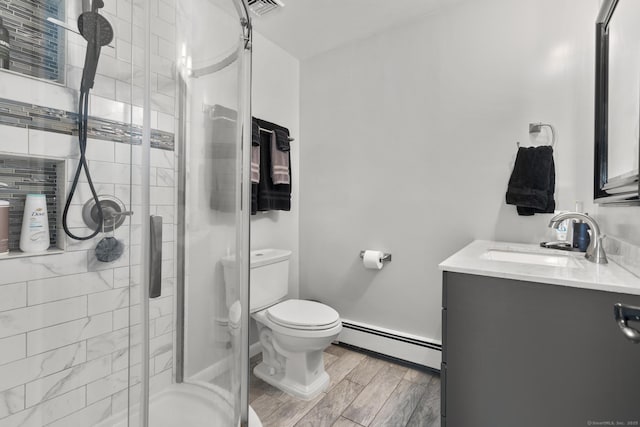 24 Pine Tree Rdg, Meriden, CT 06450 - bathroom featuring baseboard heating, vanity, a shower stall, and wood finished floors