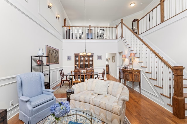 18 Briar Ridge Dr Unit 18, Bethel, CT 06801 - living area featuring a chandelier, stairway, wood finished floors, a decorative wall, and wainscoting