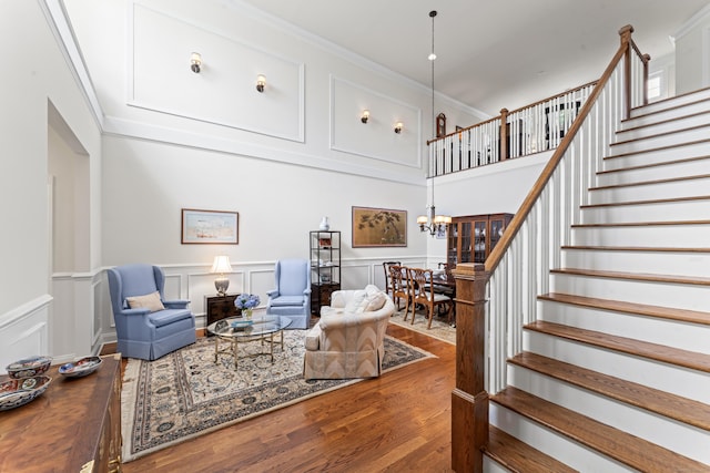 18 Briar Ridge Dr Unit 18, Bethel, CT 06801 - living area with a decorative wall, a chandelier, stairs, wood finished floors, and crown molding