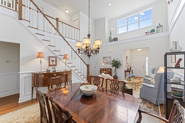 18 Briar Ridge Dr Unit 18, Bethel, CT 06801 - dining space featuring stairs, light wood finished floors, a high ceiling, a chandelier, and wainscoting