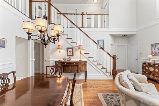 18 Briar Ridge Dr Unit 18, Bethel, CT 06801 - dining room featuring a towering ceiling, wood finished floors, stairway, a chandelier, and ornamental molding