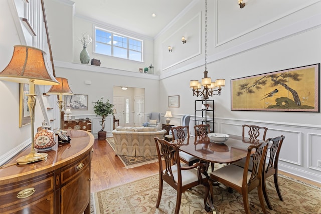 18 Briar Ridge Dr Unit 18, Bethel, CT 06801 - dining area featuring light wood finished floors, a chandelier, wainscoting, ornamental molding, and a high ceiling
