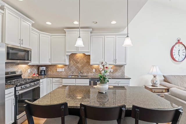 18 Briar Ridge Dr Unit 18, Bethel, CT 06801 - kitchen with appliances with stainless steel finishes, a breakfast bar, white cabinetry, dark stone countertops, and recessed lighting
