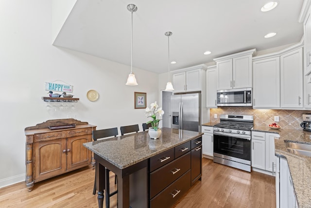18 Briar Ridge Dr Unit 18, Bethel, CT 06801 - kitchen with appliances with stainless steel finishes, white cabinetry, decorative backsplash, light wood finished floors, and recessed lighting
