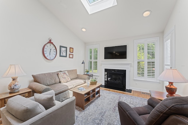 18 Briar Ridge Dr Unit 18, Bethel, CT 06801 - living area with a glass covered fireplace, wood finished floors, recessed lighting, a skylight, and vaulted ceiling