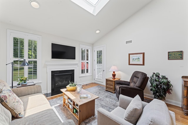 18 Briar Ridge Dr Unit 18, Bethel, CT 06801 - living room with a skylight, recessed lighting, wood finished floors, a glass covered fireplace, and lofted ceiling