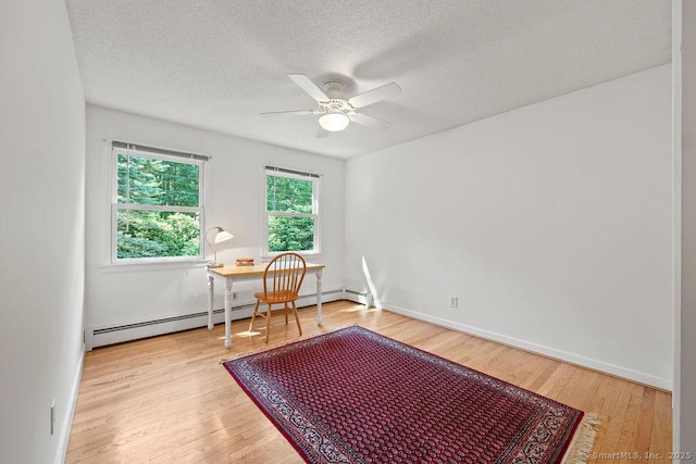 267 Jagger Ln, Hebron, CT 06248 - empty room with a ceiling fan, wood finished floors, a textured ceiling, a baseboard radiator, and an office area