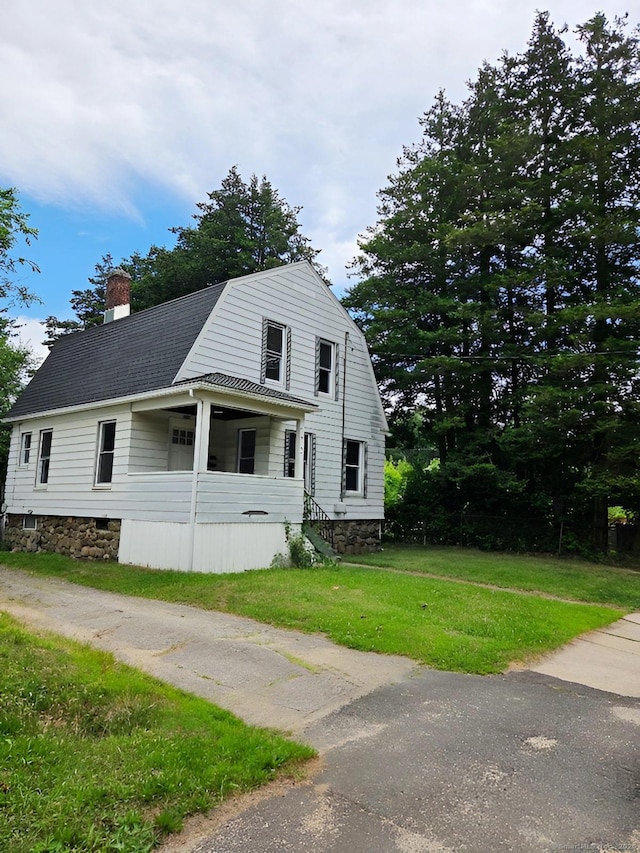 181 Plank Rd, Waterbury, CT 06705 - colonial inspired home with a gambrel roof, a chimney, a shingled roof, and a front yard