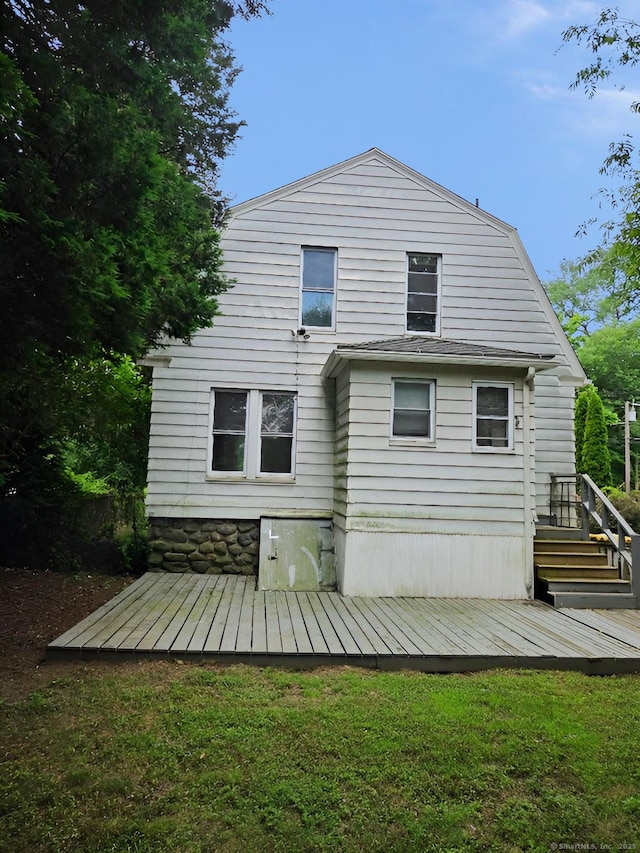 181 Plank Rd, Waterbury, CT 06705 - rear view of house with a deck, a gambrel roof, and a yard