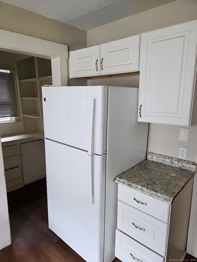 181 Plank Rd, Waterbury, CT 06705 - kitchen with freestanding refrigerator, dark wood-type flooring, white cabinetry, and light stone counters
