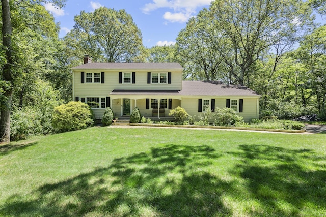 19 Buttercup Ln, Shelton, CT 06484 - colonial-style house with a chimney, a porch, and a front yard