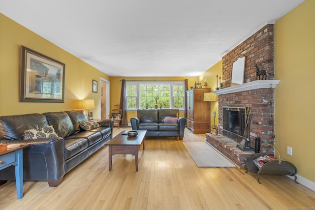 19 Buttercup Ln, Shelton, CT 06484 - living area featuring wood finished floors and a brick fireplace
