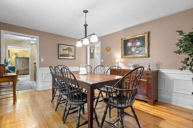19 Buttercup Ln, Shelton, CT 06484 - dining area featuring wainscoting, light wood finished floors, and a decorative wall
