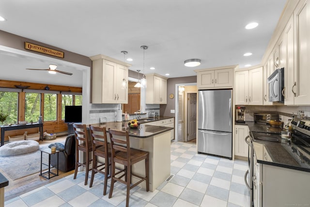 19 Buttercup Ln, Shelton, CT 06484 - kitchen with stainless steel appliances, a peninsula, light flooring, backsplash, and recessed lighting