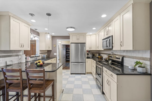 19 Buttercup Ln, Shelton, CT 06484 - kitchen with stainless steel appliances, a peninsula, light floors, decorative backsplash, and recessed lighting