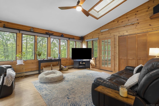 19 Buttercup Ln, Shelton, CT 06484 - living area with lofted ceiling, a skylight, wooden walls, ceiling fan, and wood finished floors