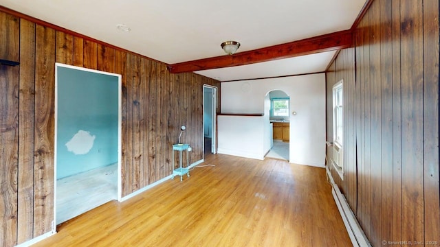 36 Merwin Ave, Milford, CT 06460 - spare room with arched walkways, a baseboard radiator, beam ceiling, wood finished floors, and wooden walls