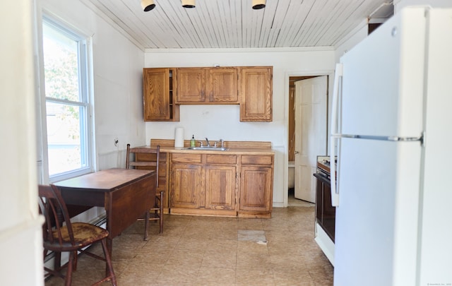 36 Merwin Ave, Milford, CT 06460 - kitchen with freestanding refrigerator, brown cabinetry, wood ceiling, range, and light countertops