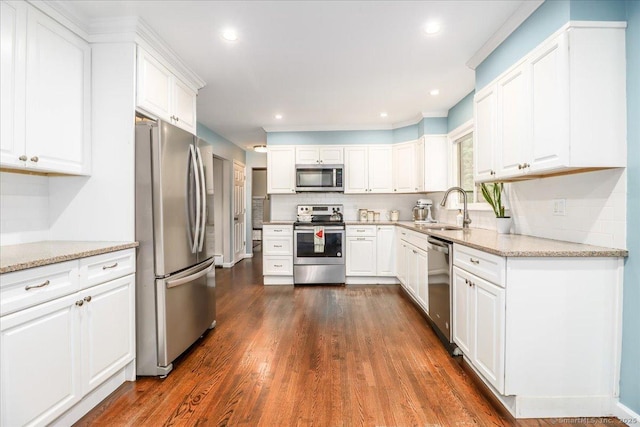 17 Robinhood Rd, Danbury, CT 06811 - kitchen featuring appliances with stainless steel finishes, decorative backsplash, dark wood-style floors, white cabinetry, and light stone countertops