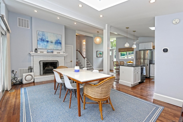 23 Briarwood Dr, Old Saybrook, CT 06475 - dining room with dark wood-style flooring, a fireplace, recessed lighting, stairs, and a skylight