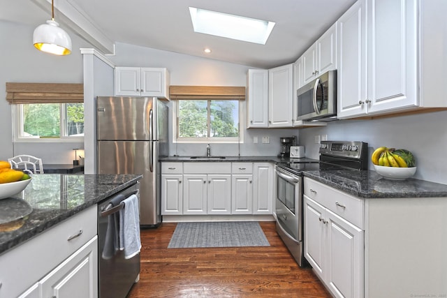 23 Briarwood Dr, Old Saybrook, CT 06475 - kitchen featuring stainless steel appliances, a skylight, white cabinetry, healthy amount of natural light, and vaulted ceiling