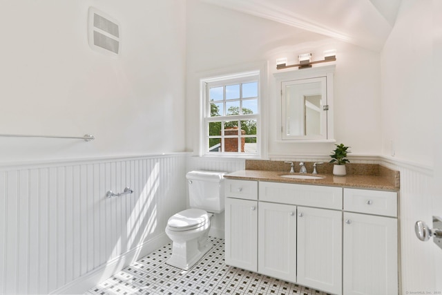36 Hendrie Ave, Greenwich, CT 06878 - bathroom with wainscoting, vanity, tile patterned floors, and lofted ceiling
