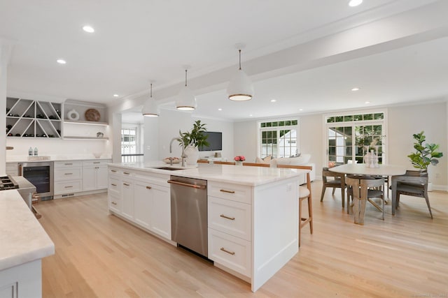 36 Hendrie Ave, Greenwich, CT 06878 - kitchen with stainless steel dishwasher, wine cooler, open shelves, crown molding, and light wood-style flooring