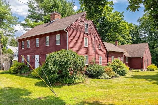 889 S Main St, Southington, CT 06479 - view of home's exterior with a chimney, a shingled roof, and a yard
