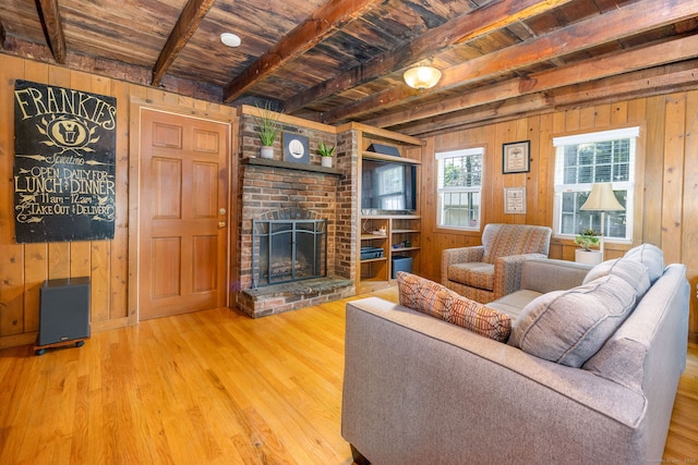 889 S Main St, Southington, CT 06479 - living room with wood walls, wood finished floors, a wood ceiling with exposed beams, and a brick fireplace