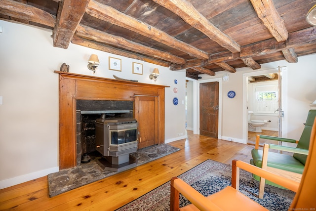889 S Main St, Southington, CT 06479 - living room with a wooden ceiling with exposed beams, a wood stove, and hardwood / wood-style floors
