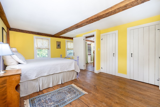 889 S Main St, Southington, CT 06479 - bedroom with multiple closets, beamed ceiling, and hardwood / wood-style floors