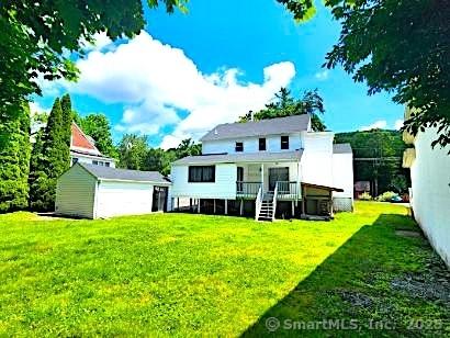 23 Norfolk Rd, Torrington, CT 06790 - rear view of house featuring a lawn, a deck, and an outbuilding