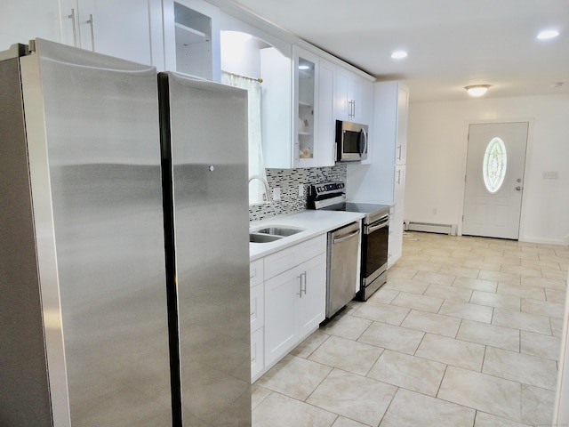 23 Norfolk Rd, Torrington, CT 06790 - kitchen with stainless steel appliances, a baseboard heating unit, tasteful backsplash, light countertops, and glass insert cabinets