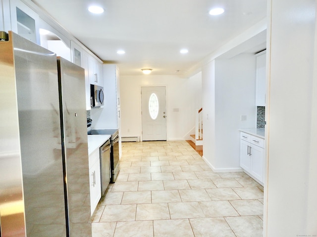 23 Norfolk Rd, Torrington, CT 06790 - kitchen with stainless steel appliances, light countertops, white cabinets, recessed lighting, and a baseboard heating unit