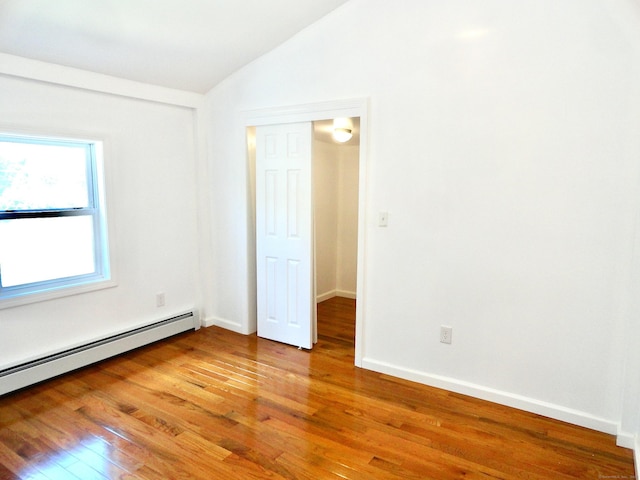 23 Norfolk Rd, Torrington, CT 06790 - empty room with vaulted ceiling, light wood-type flooring, and a baseboard radiator