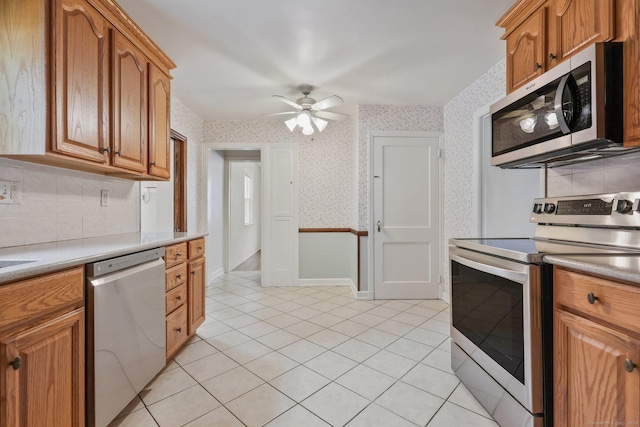 22 Brundage St, Stamford, CT 06907 - kitchen featuring stainless steel appliances, wallpapered walls, light tile patterned flooring, backsplash, and ceiling fan