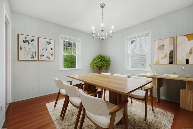 22 Brundage St, Stamford, CT 06907 - dining room featuring wood finished floors, a chandelier, and a decorative wall
