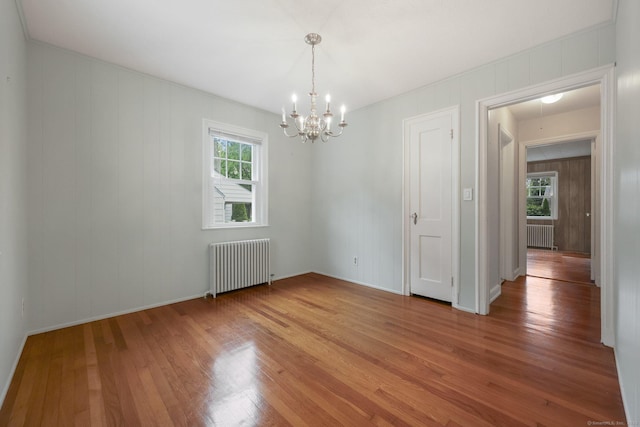 22 Brundage St, Stamford, CT 06907 - empty room featuring radiator heating unit, a chandelier, plenty of natural light, and light wood-style floors