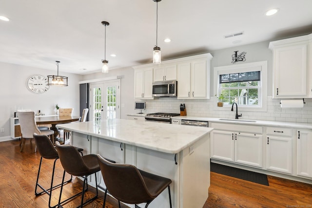 15 Wondy Way, Danbury, CT 06811 - kitchen featuring appliances with stainless steel finishes, a center island, decorative backsplash, french doors, and dark wood-style floors