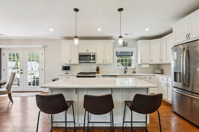 15 Wondy Way, Danbury, CT 06811 - kitchen with appliances with stainless steel finishes, a center island, decorative backsplash, white cabinetry, and recessed lighting
