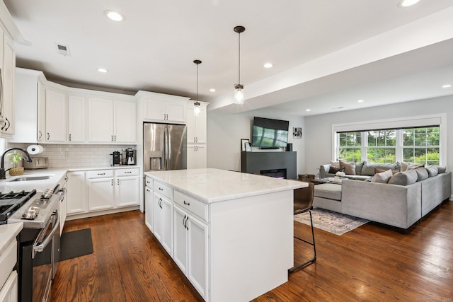 15 Wondy Way, Danbury, CT 06811 - kitchen featuring stainless steel appliances, a kitchen island, dark wood-type flooring, a kitchen bar, and white cabinetry
