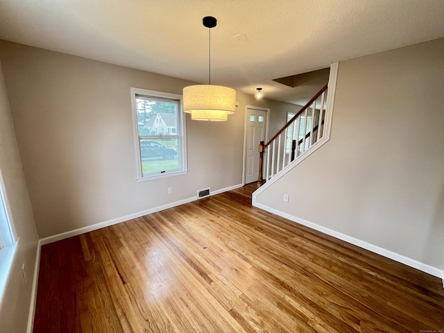 212 Clement Rd, East Hartford, CT 06118 - unfurnished dining area featuring wood finished floors and stairway