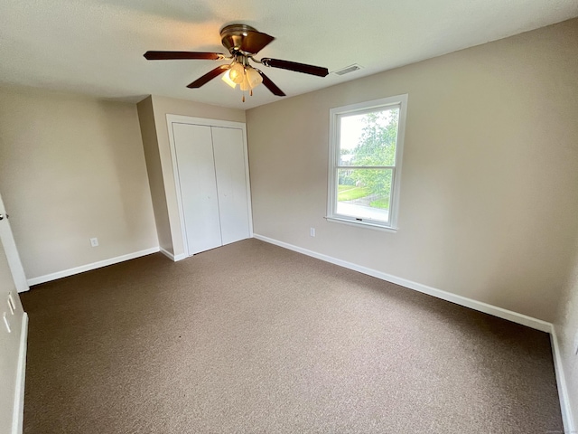 212 Clement Rd, East Hartford, CT 06118 - unfurnished bedroom with a closet, dark colored carpet, and ceiling fan