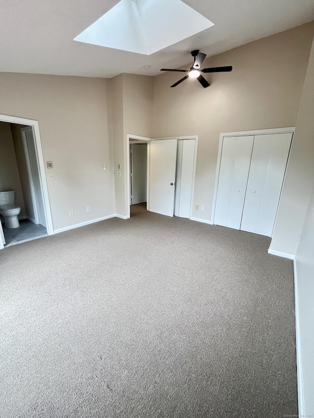 212 Clement Rd, East Hartford, CT 06118 - unfurnished bedroom featuring a skylight, multiple closets, carpet flooring, vaulted ceiling, and a ceiling fan