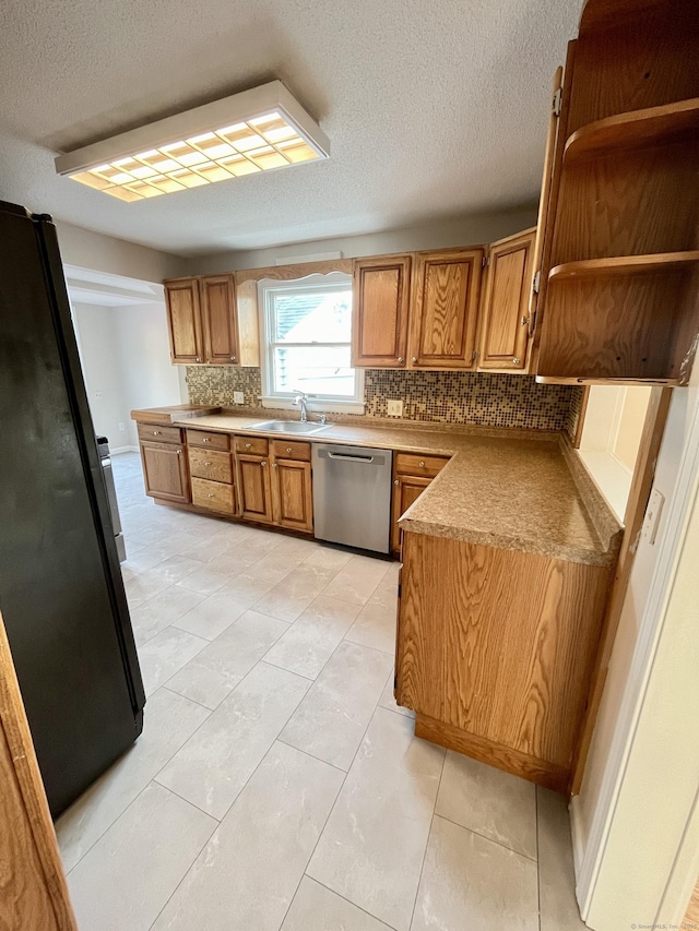 212 Clement Rd, East Hartford, CT 06118 - kitchen featuring stainless steel dishwasher, freestanding refrigerator, decorative backsplash, brown cabinets, and a textured ceiling