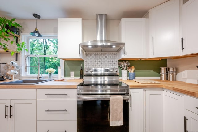 81 Burwell Rd, New Hartford, CT 06057 - kitchen with wall chimney range hood, stainless steel electric range, wooden counters, white cabinets, and pendant lighting